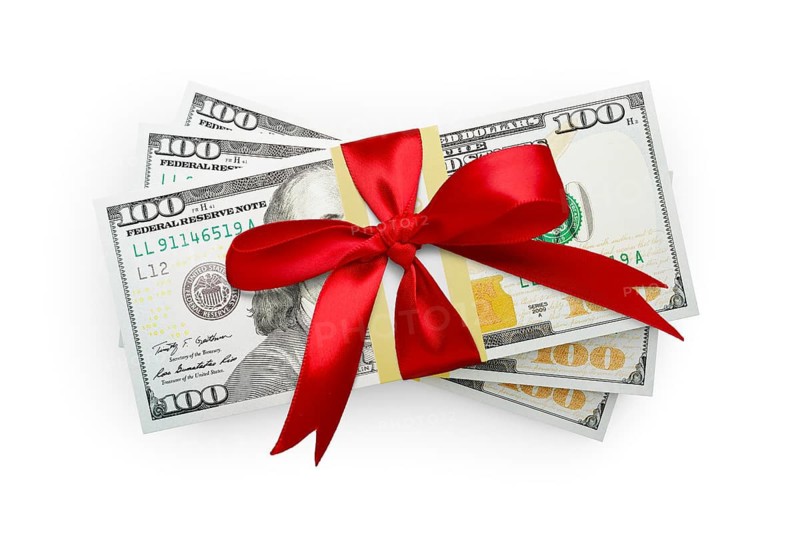 Thirty thousand dollars stack of one hundred dollar bills wrapped in a red bow isolated on a white background