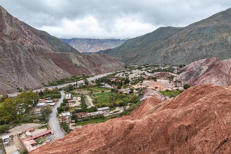Explore the picturesque village of Purmamarca in Jujuy, Argentina, nestled amid stunning multicolored hills. The vibrant landscape offers a captivating blend of nature and culture