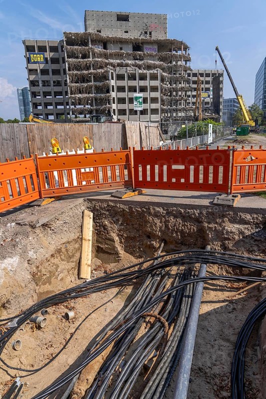 Construction site on Haroldstraße, demolition of a former office building, after complete gutting only the concrete parts remain, exposed supply cables, electricity, telecommunications, etc. Düsseldorf, North Rhine-Westphalia, Germany