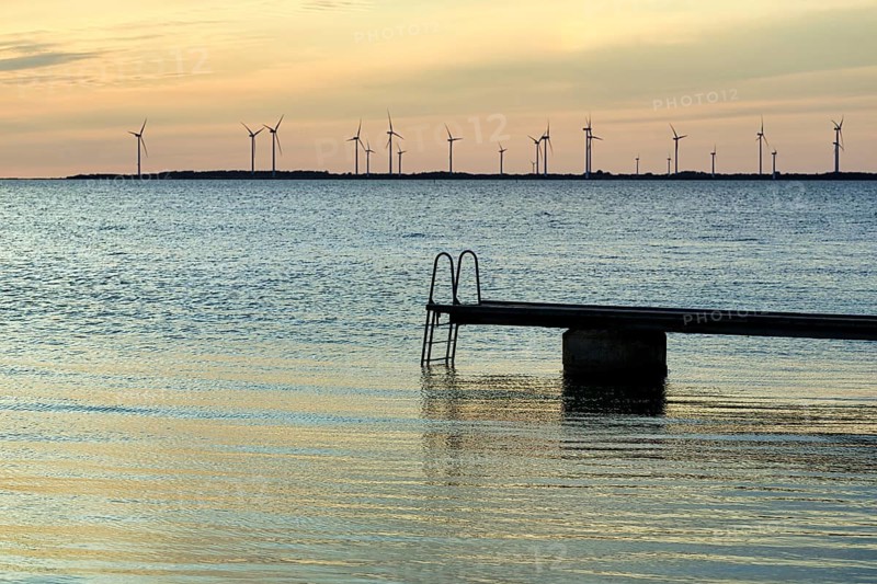 Seaside jetty, bathing area, wind farm on the horizon, sunset, back light, Baltic Sea, Burgsvik, Gotland island, Sweden