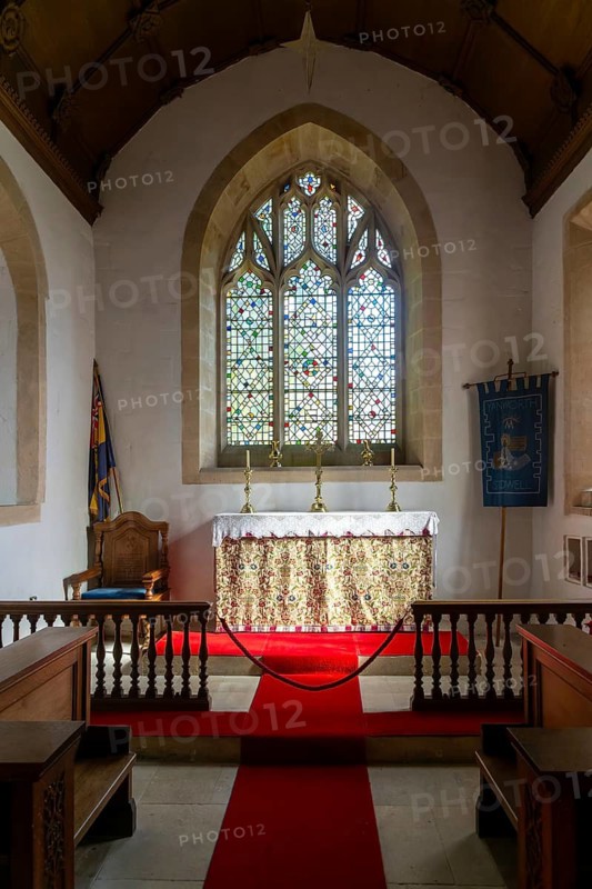 Interior view of east window and altar, church of Saint Michael, Yanworth, Gloucestershire, England, UK