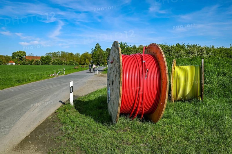 Bönen, North Rhine-Westphalia, Germany - Internet broadband expansion in the countryside, construction site for laying fibre optic cable, cable drum with fibre optic cable, new construction of fibre optic routes, fast Internet, DSL cable connection for households. Bönen is a municipality in the district of Unna in North Rhine-Westphalia
