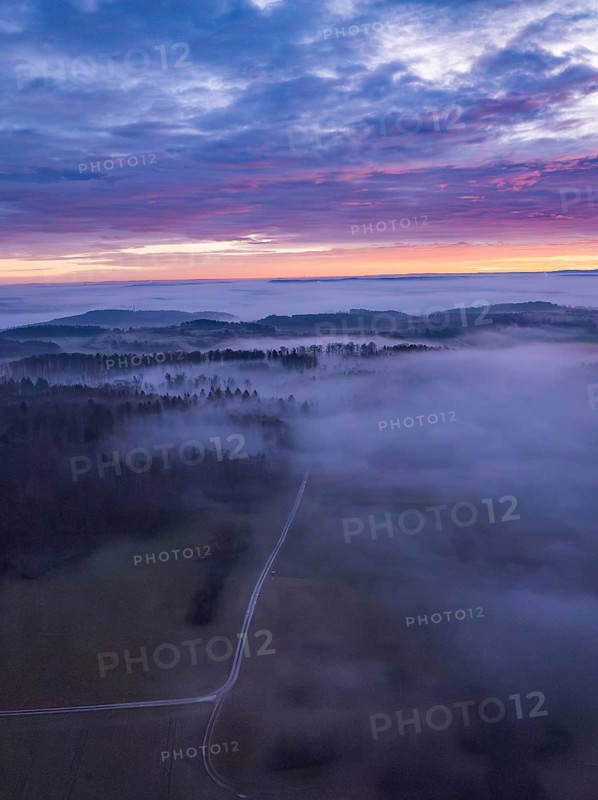View of a misty landscape with wide fields, hills and enchanting morning sky, Calw, Black Forest, Germany