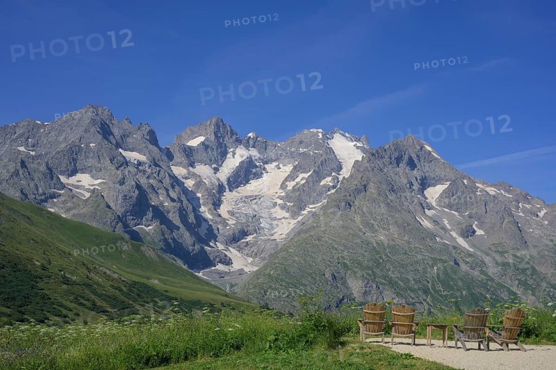 Rest area with table and chairs with view of Pointe Piaget and La Meije as seen from the botanical garden Jardin du Lautaret, Villar-d'Arêne, Département Hautes-Alpes, France