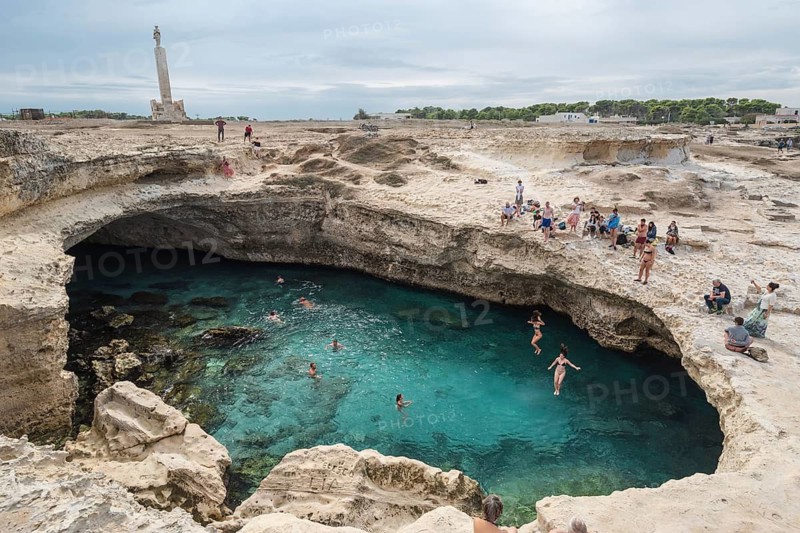 ROCA VECCHIA, ITALY - SEPTEMBER 28, 2018: Grotta Della Poesia is a very popular tourist attraction in region Plugia. People jump to the water from the rock