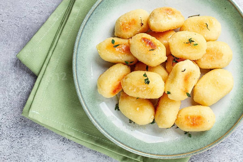 Stuffed gnocchi with cheese, Italian dumplings, garnished with parmesan cheese, no people