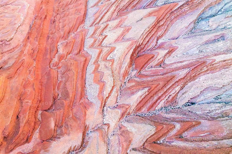 Striking aerial view of the patterned sandstone canyons near the San Juan River in Utah, showcasing vivid earth tones and abstract natural designs