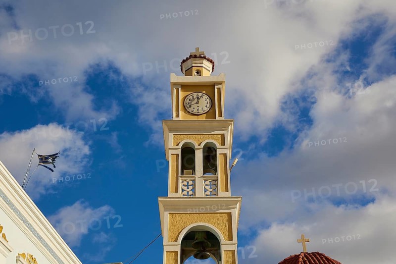 Paraklesio Church, Close-up of a clock tower under a cloudy sky in yellow and white colours, Colourful mountain village, Morning light, Olymbos, Karpathos, Dodecanese, Greek Islands, Greece