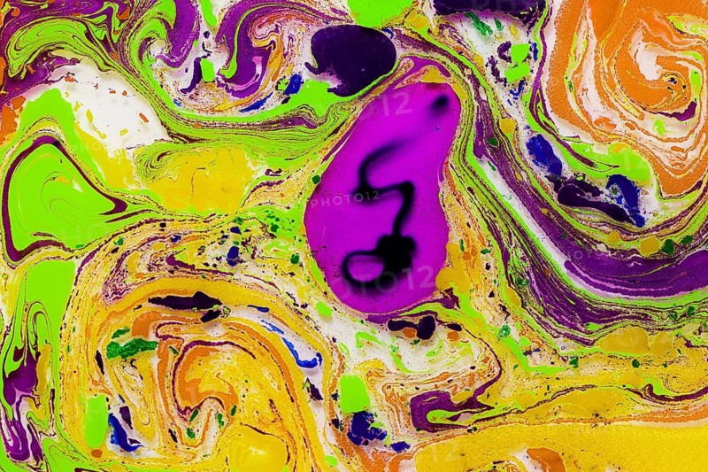 A vivid abstract pattern created by marbling techniques, featuring swirling colors such as purple, yellow, green, and more. The image is suitable for vibrant backgrounds and artistic designs