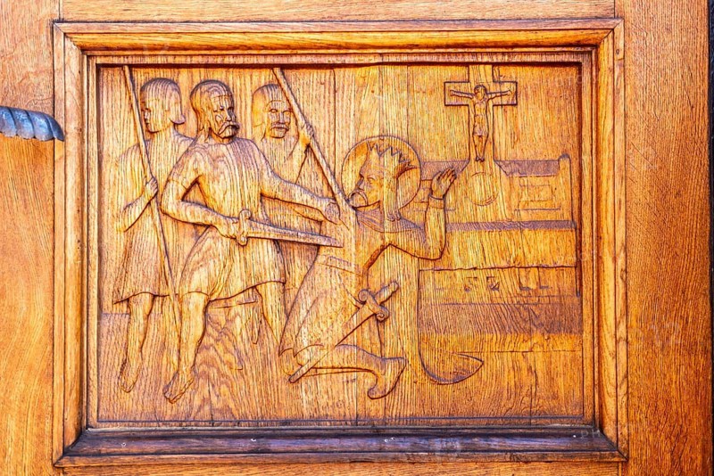 Odense, early Gothic St Albani Church, Roman Catholic church, entrance portal with wood carvings, assassination of the Danish king Knud in 1086, Fyn, island of Funen, Denmark