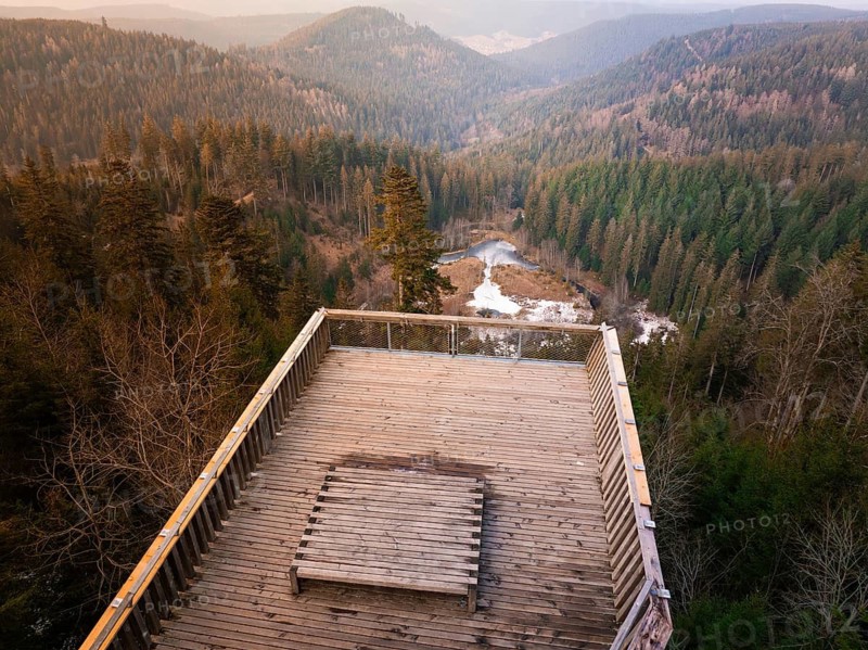 View over wooded hills and valleys from a wooden terrace, Ellbachseeblick viewing platform, Baiersbronn, Black Forest, Germany