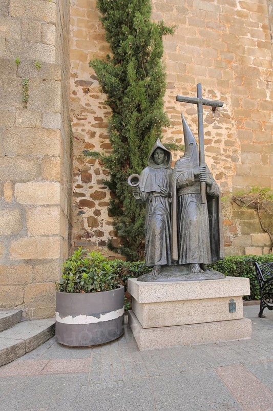 Homage to Holy Week, two sinister bronze sculptures with cross with pointed cap, memorial the week in front of Easter, Plaza de San Juan, UNESCO old town, Caceres, Extremadura