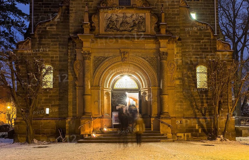 Church portal to the New Church of St Peter and Paul, churchgoers streaming into the church, Coswig, Saxony, Germany