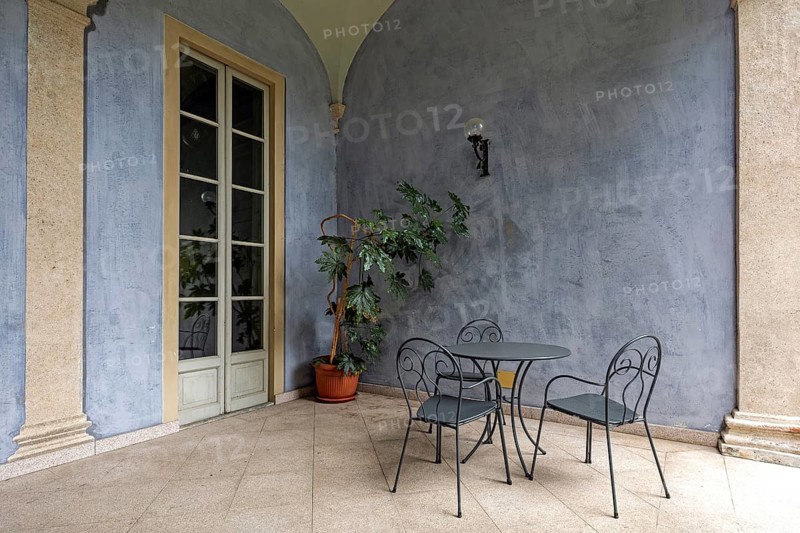 Terrace with table and chairs in the historic centre of Cannobio, Lake Maggiore, province of Verbano-Cusio-Ossola, Piedmont region, Italy