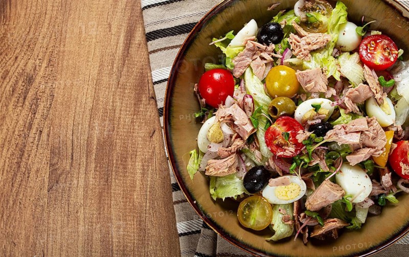 Salad with canned tuna, vegetable salad with quail eggs, lettuce, red onion, cherry tomatoes, olives, keto food, healthy food, homemade, no people