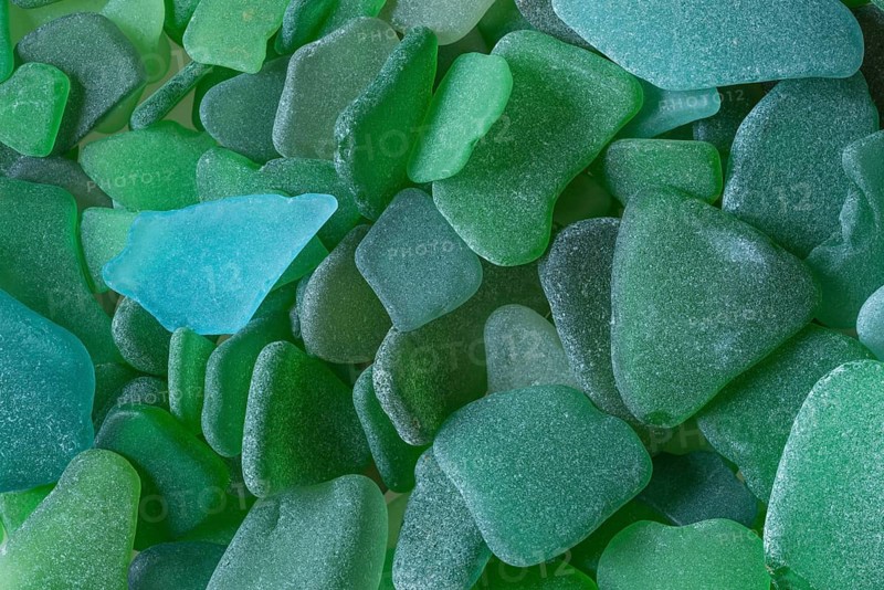 Green broken glass cut by the sea, sea glass, sea glass, beach glass from the North Sea