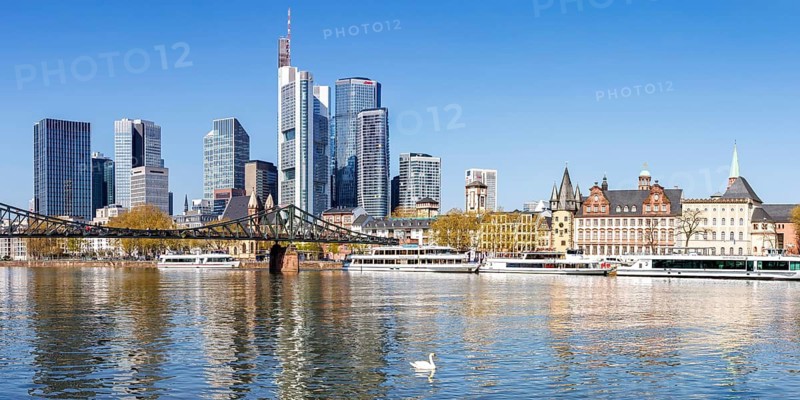 Frankfurt skyline skyscrapers with banks on the river Main with excursion boats and Eiserner Steg panorama in Frankfurt, Germany