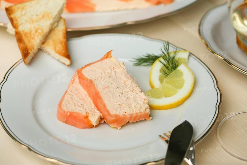 Southern German cuisine, salmon trout terrine arranged on a plate, salmon terrine with trout fillets, fish dish, salmon fillets, smoked salmon, starter, fine dining, Sunday crockery with gold rim, grandma's service, lemons, dill, fish cutlery, toast, food photography, studio, Germany