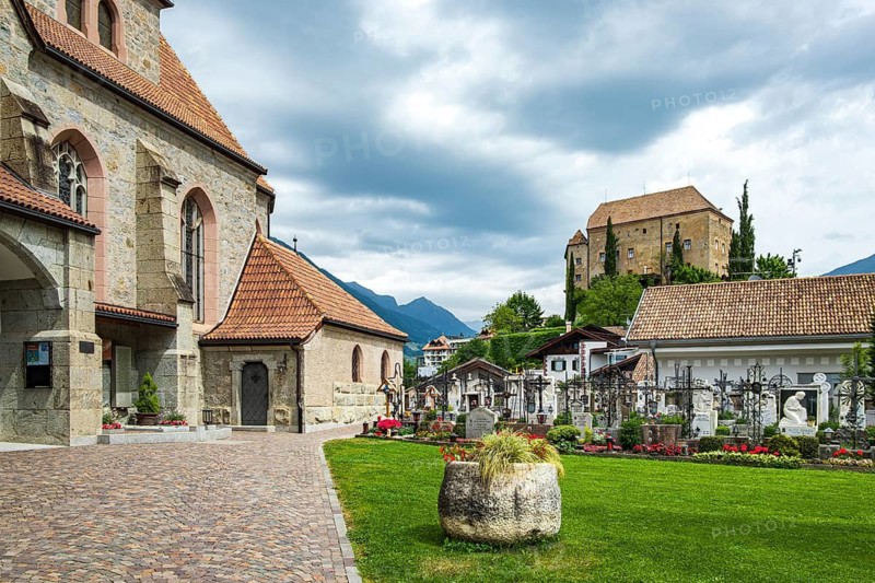 Picturesque cemetery with a view of Scena Castle, on the church hill of Scena above Merano, in the Burggrafenamt, South Tyrol, Italy, for editorial use only