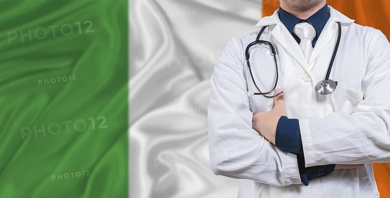 Male doctor with stethoscope on Irish flag. Doctor holding stethoscope on Irish flag