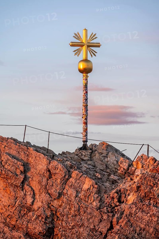 Summit of the Zugspitze with golden summit cross, alpenglow at sunset, Northern Limestone Alps, Wetterstein Mountains, Bavaria, Germany