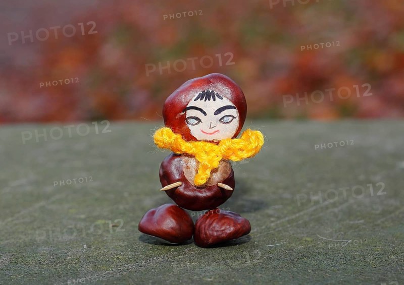 Funny chestnut figure with yellow scarf on a wall, North Rhine-Westphalia, Germany