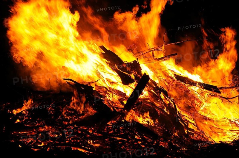 An intense fire with large flames consumes wood and produces a fierce ember, campfire, Easter fire, Bavaria