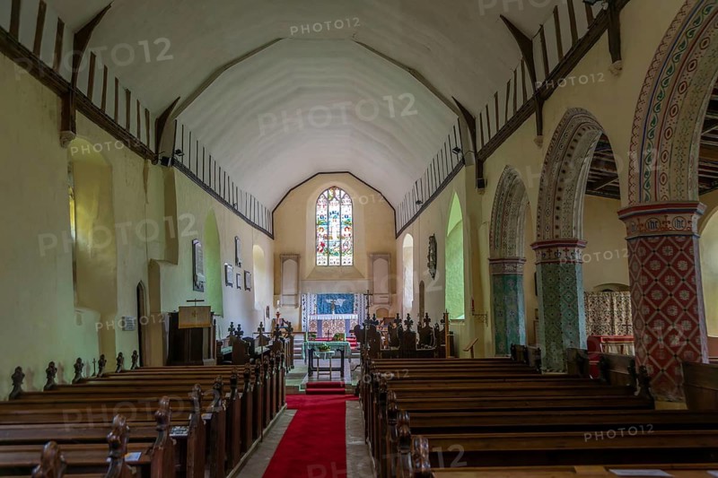Nave to altar and east window inside church of Saint Peter, Theberton, Suffolk, England, UK