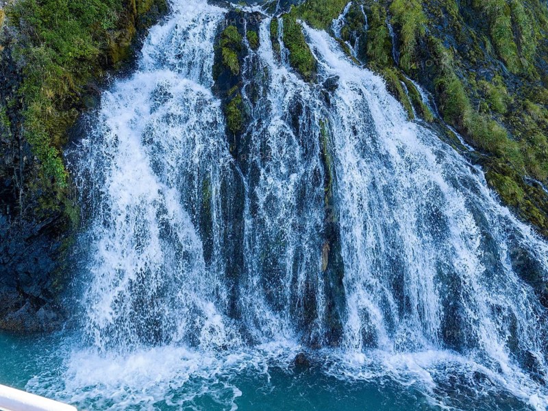 Waterfall at the Bay of Last Hope, fjords and mountains, Puerto Natales, Patagonia, Chile