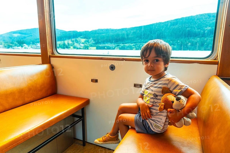 A boy on holiday inside the boat on Lake Titisee in the Black Forest, Germany