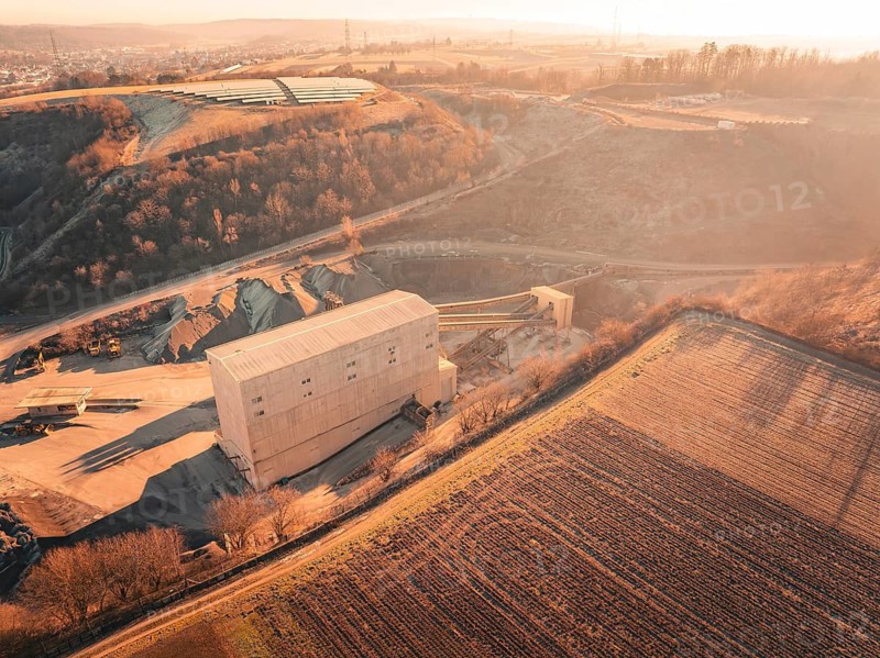 View over an industrial building and quarry in a rural, hilly area, Magstadt, Germany