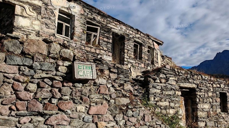 Abandoned stone houses in mountainous landscape, dilapidated architecture, Stepantsminda, Caucasus, Georgia