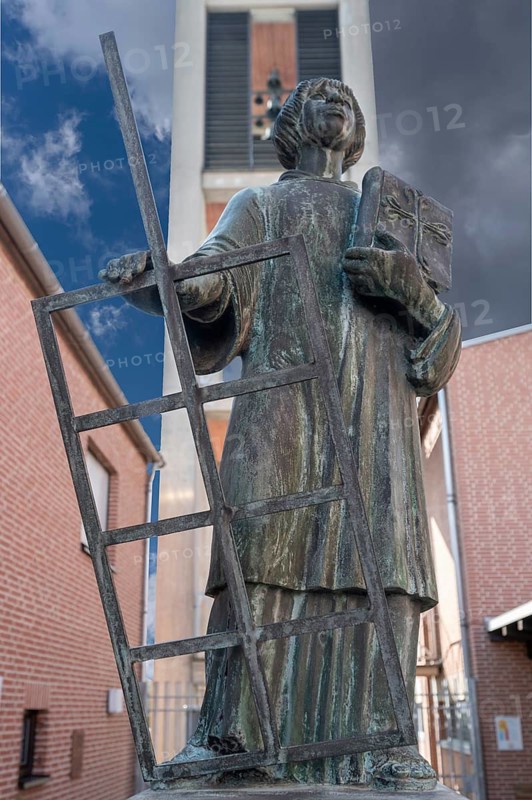 Statue of St Laurentius in front of the bell tower of St Laurentius Church, Möhrendorf, Middle Franconia, Basyern, Germany