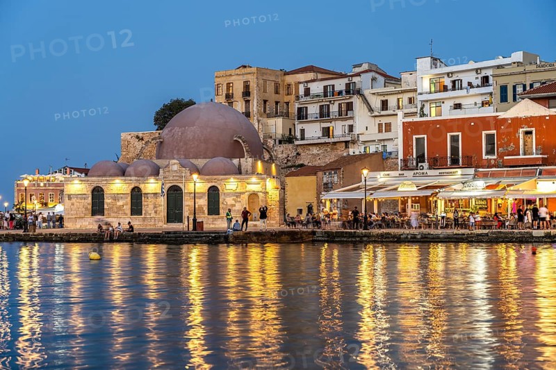 Restaurants and the Hasan Pasha Mosque at the old Venetian harbour at dusk, Chania, Crete, Greece