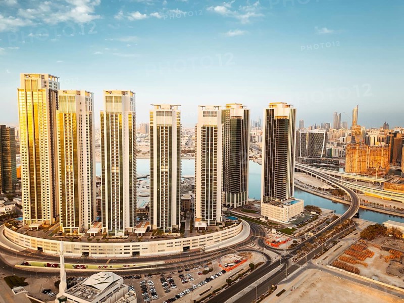 Abu Dhabi, UAE - 25th april, 2025: Abu Dhabi capital city UAE skyline with real estate buildings sunrise panorama with clear blue sky. Business real estate marina heights copy space banner