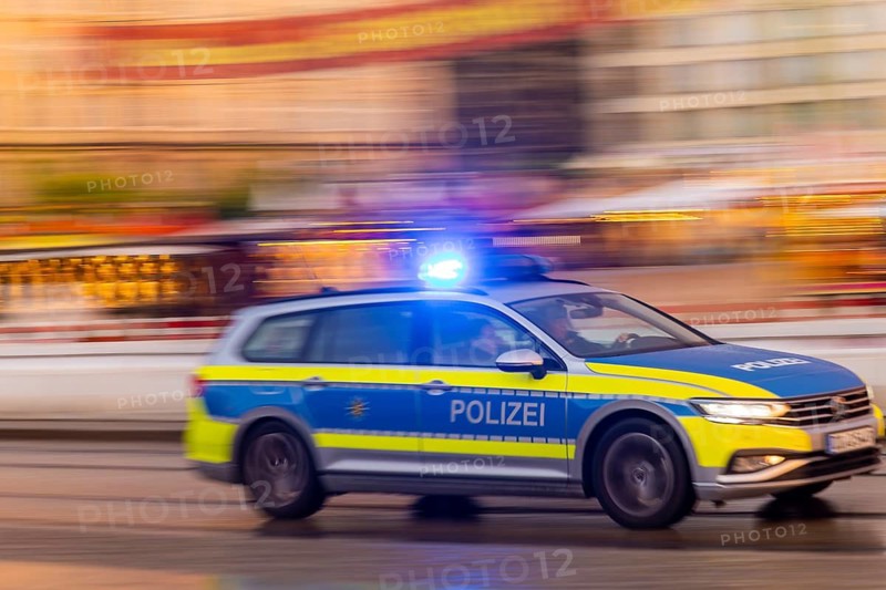 A police car on an emergency drive on Wilsdruffer Straße at Altmarkt with flashing blue lights, Dresden, Saxony, Germany