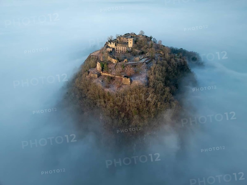 Aerial view of the Hegau volcano Hohentwiel with the upper fortress ruins in front of sunrise, rising out of the fog during an inversion, district of Constance, Baden-Württemberg, Germany