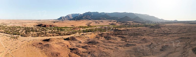 Aerial view, dry riverbed and desert landscape on the Ugab River, behind Brandberg, Erongo, Damaraland, Namibia