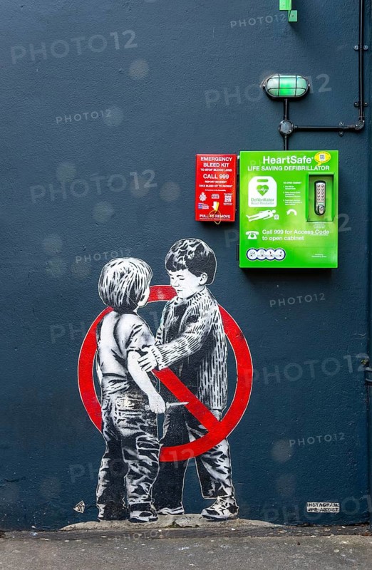 Mural street art two young boys one with knife Anti knife piece 2020 by JPS artist Jamie Scanlon, Frogmore Street, Bristol, England, UK