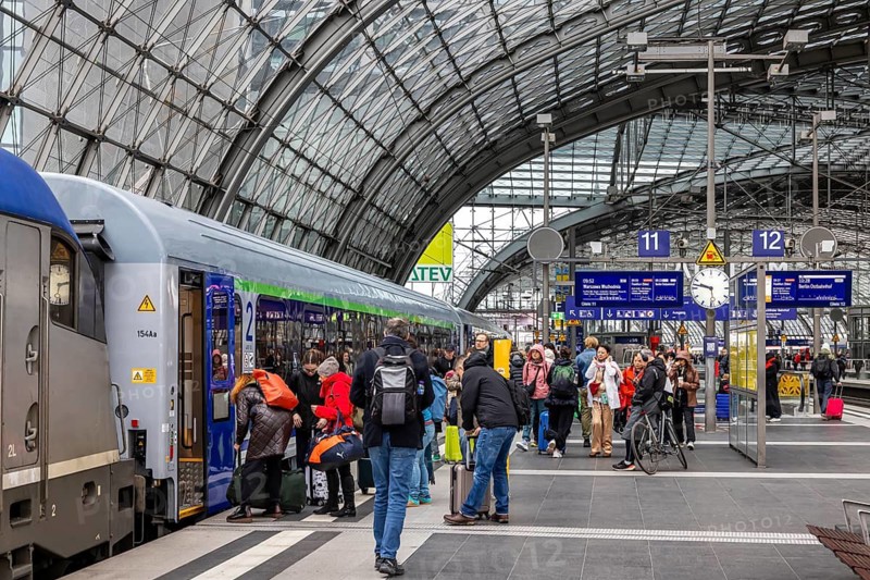 EuroCity to Warsaw at Berlin Central Station. Travelers on the platform. Berlin, Germany