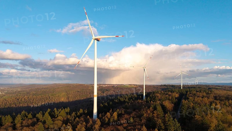 Tall wind turbines in a wooded landscape stretching into the distance under a clear sky, wind turbine, near Schorndorf-Winterbach, Baden-Württemberg, Germany