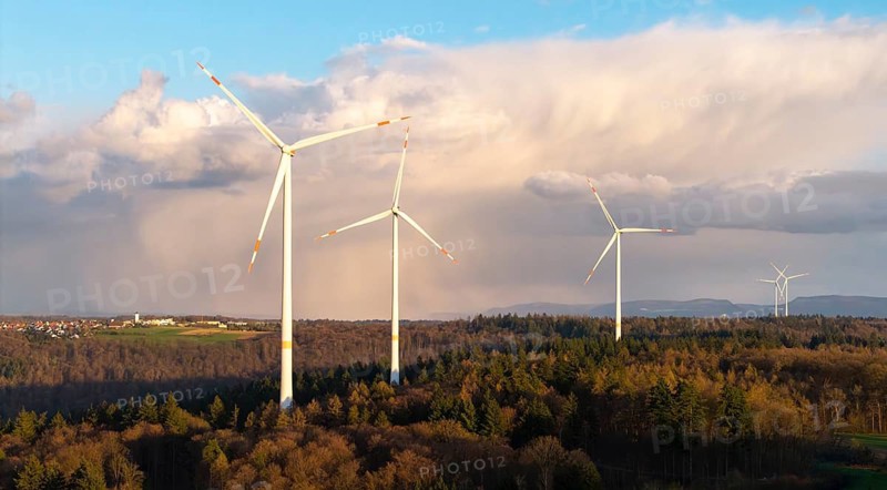 Wind turbines stand in a wooded landscape with dramatic clouds in the background, wind turbine, near Schorndorf-Winterbach, Baden-Württemberg, Germany