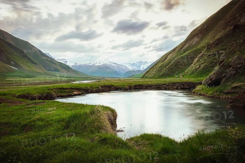 Scenic Truso Valley in Georgia with winding river, green meadows, and Caucasus mountains in background, popular hiking and trekking destination near Kazbegi, eco tourism and nature landscape
