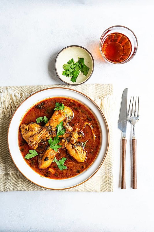 Traditional Georgian chakhokhbili features tender chicken cooked in a flavorful tomato sauce with paprika and coriander. A delightful taste of authentic Georgian cuisine