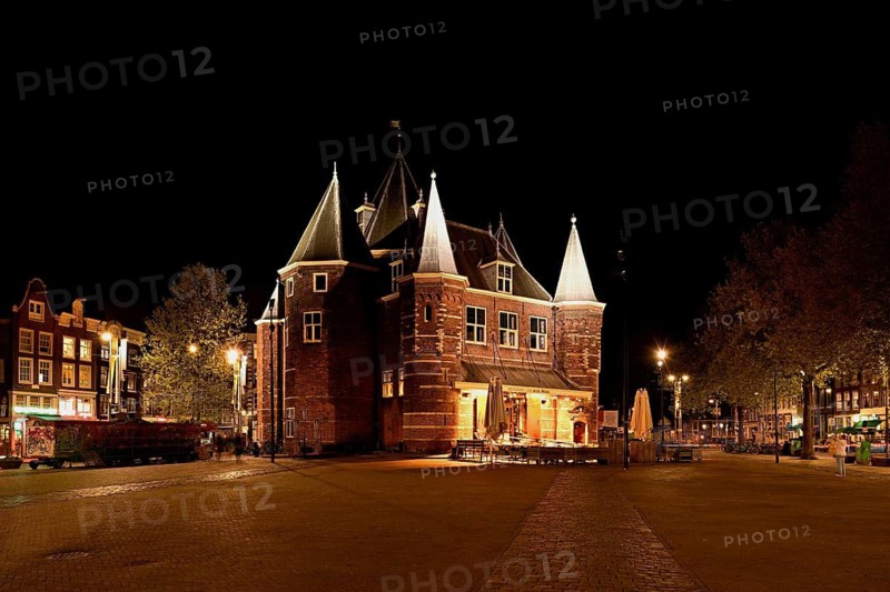 Medieval building De Waag illuminated at night, at Nieuwmarkt, Amsterdam, North Holland, Netherlands