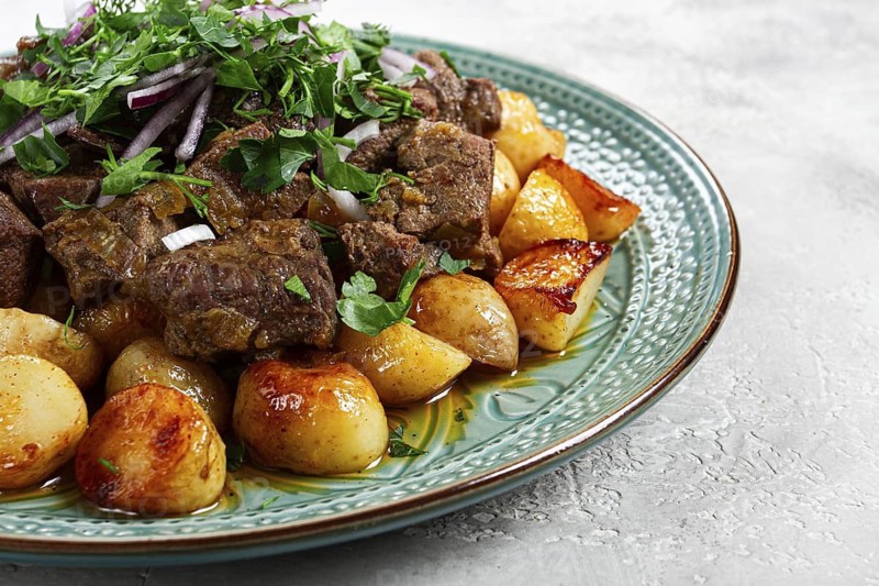 Kuyrdak, roast offal with potatoes and fresh herbs, homemade in Kazakh, no people