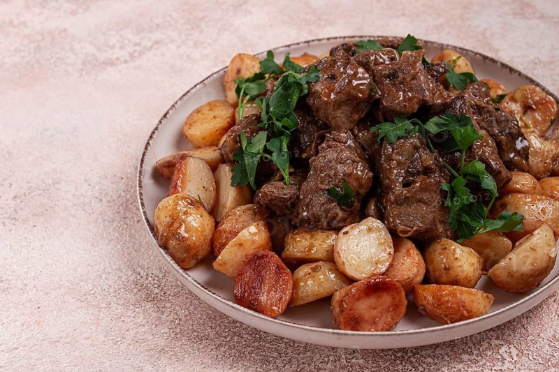 Kuyrdak, roast offal with potatoes and fresh herbs, homemade in Kazakh, no people