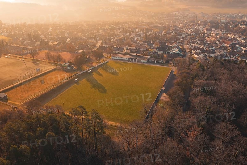Aerial view of a soccer field and a settlement in a hilly landscape, Gechingen, Calw district, Germany