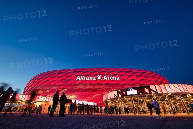 Visitors, fans, entrance area of the Allianz Arena, illuminated, overview, blue hour, in front of a Bundesliga game, Allianz Arena, Munich, Bayern, Germany