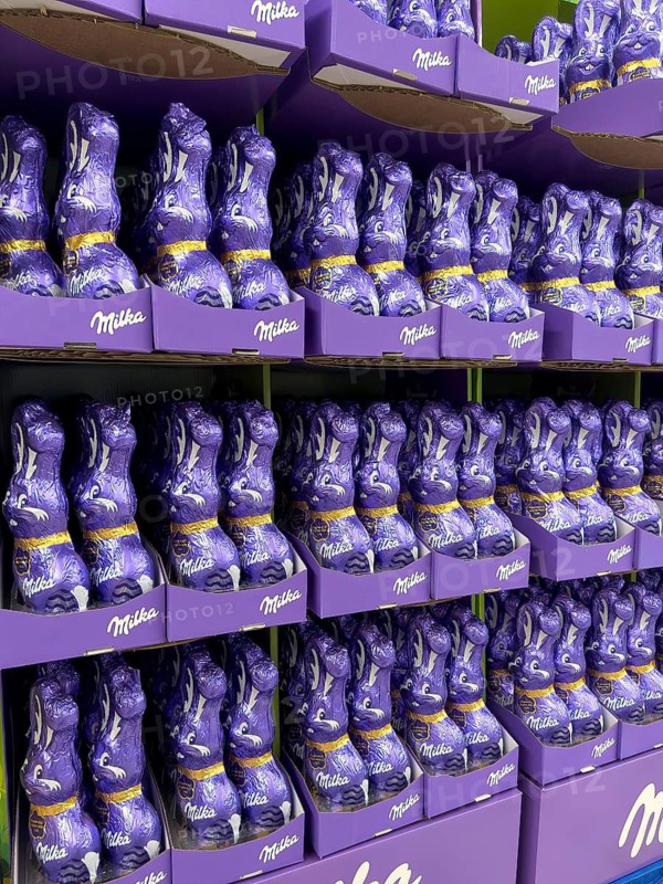 Display on the shelf of retail wholesale of chocolate Easter bunnies Easter bunnies Easter bunny brand Milka made of chocolate wrapped in purple purple tinfoil paper, Germany